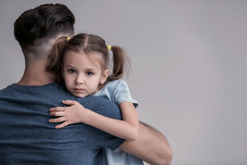 Child Looks Over Father's Shoulder