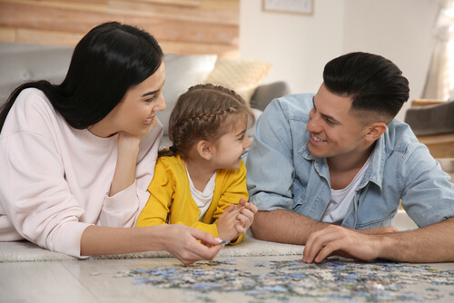 Newly Divorced couple builds puzzle with daughter