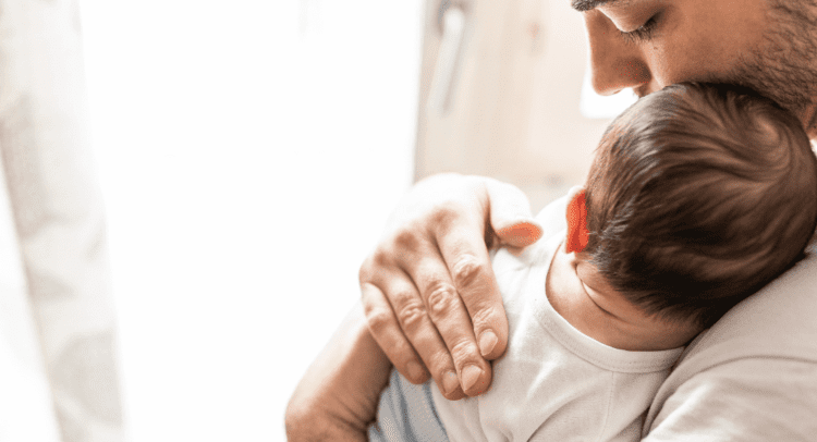 father holds newborn