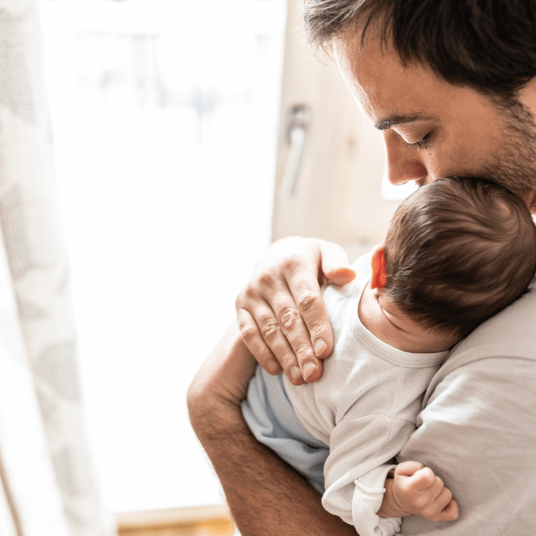 father holds newborn