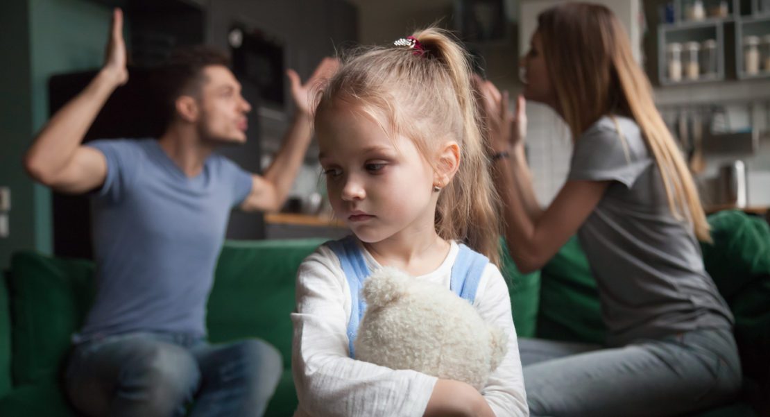 Kid daughter feels upset while parents fighting at background